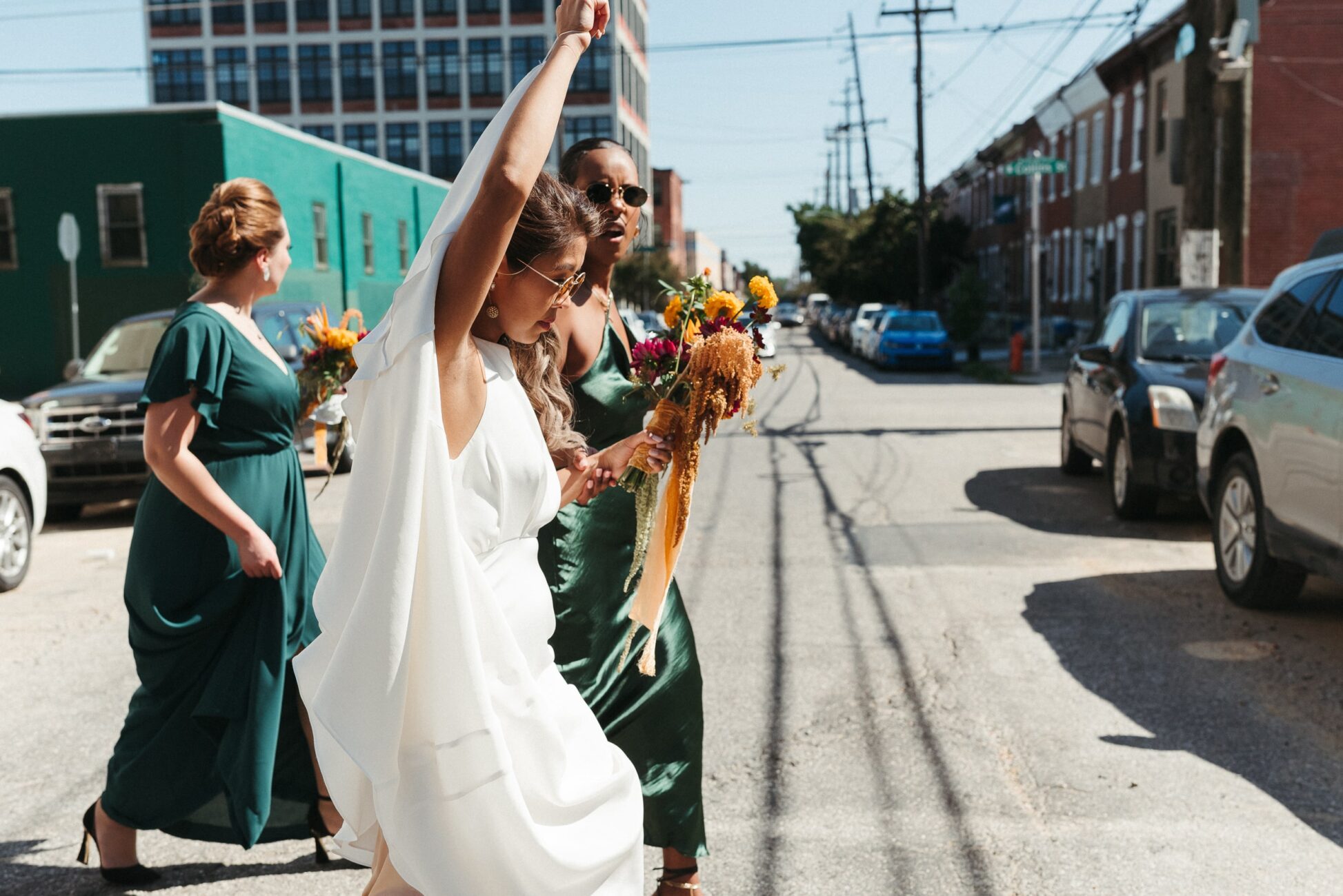 A micro wedding Philadelphia bride and bridesmaids walks to their reception