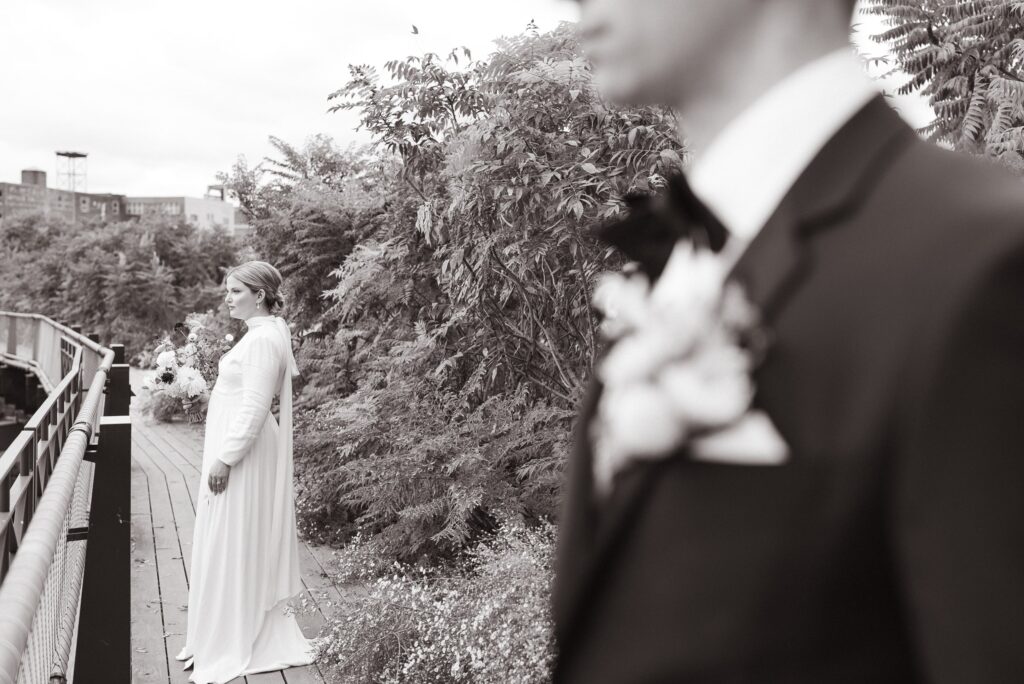 The bride and groom stand looking out on the Rail Park for their nontraditional wedding