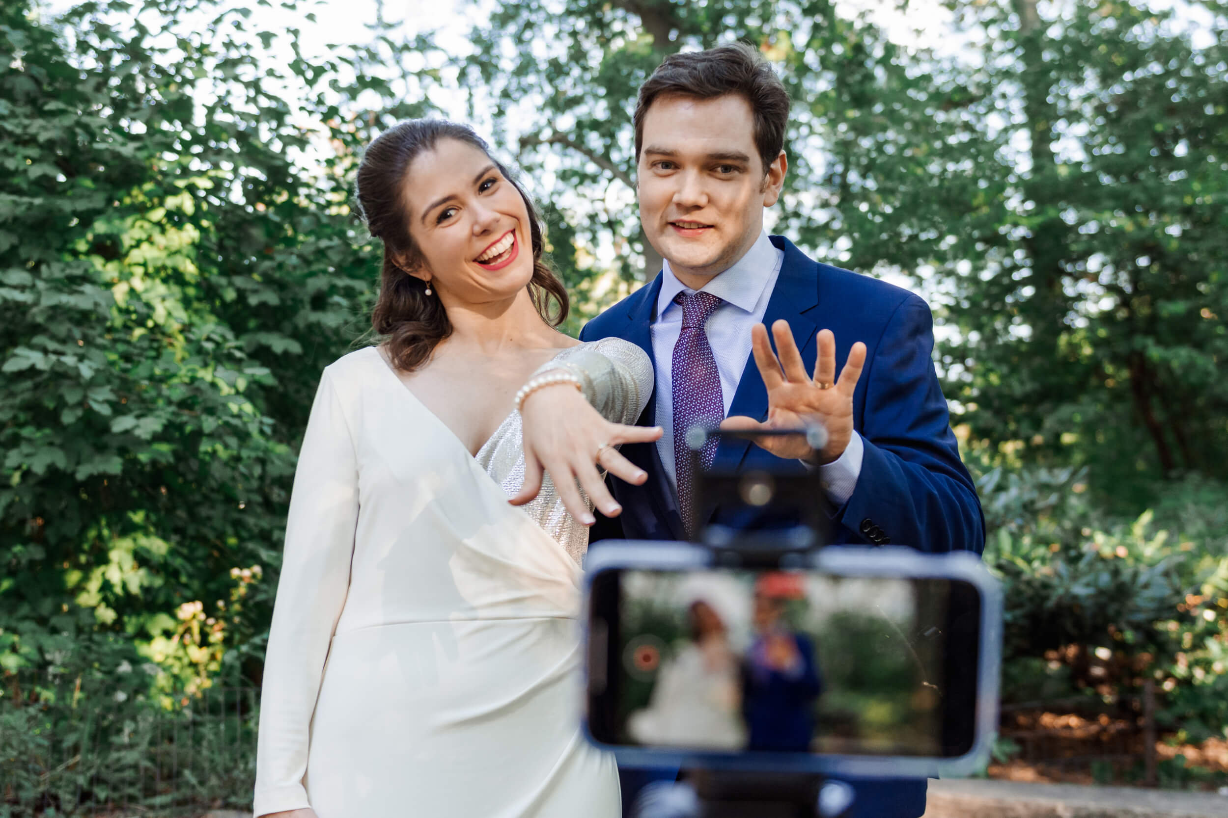 Joshua and Lauren live streaming their wedding from Central Park showing their rings to the camera