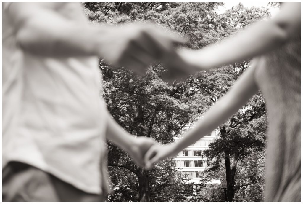 The couple holds hands in the park for engagement photos in Philadelphia