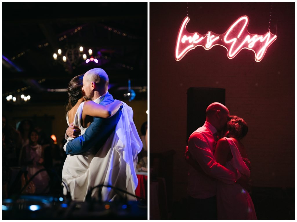 The couple embraces under a neon sign at their micro wedding in Philadelphia
