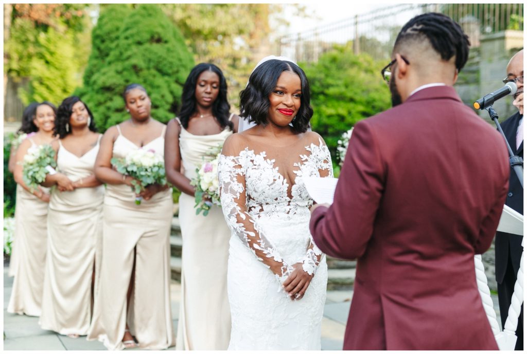 Bride listens to groom's vows during wedding photography in philadelphia
