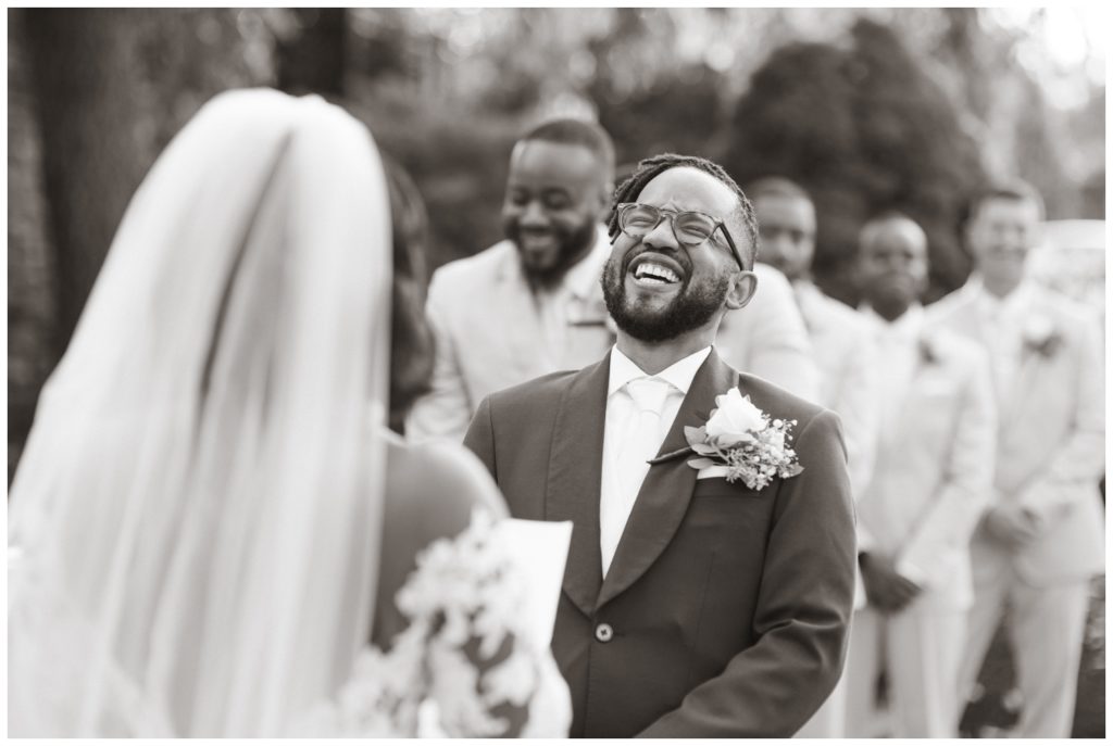 Groom laughs during ceremony in wedding photography in philadelphia