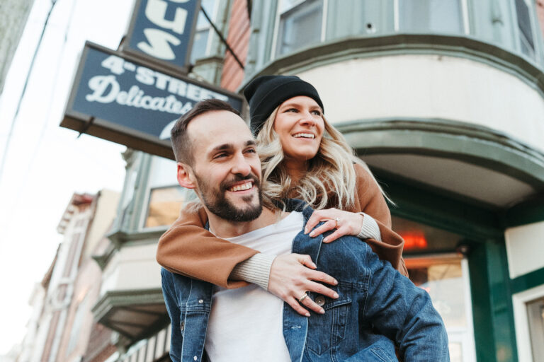 Casual Engagement Shoot in Downtown Philadelphia: Engaged couple smiling as Matt gives Lindsey a piggyback ride