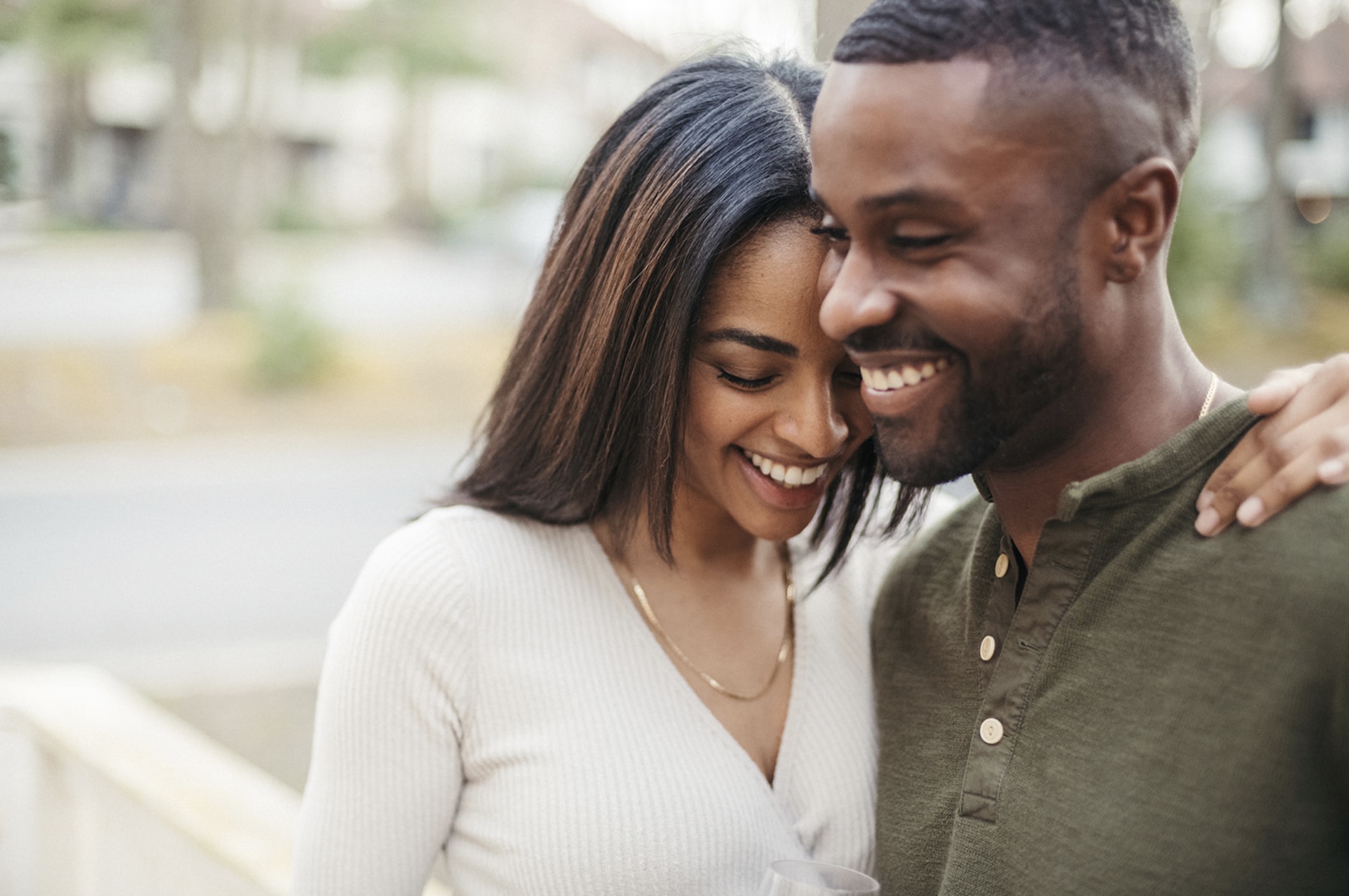 Couple smiling as they stand next to each other during their engagement session with Jason Moody Photography