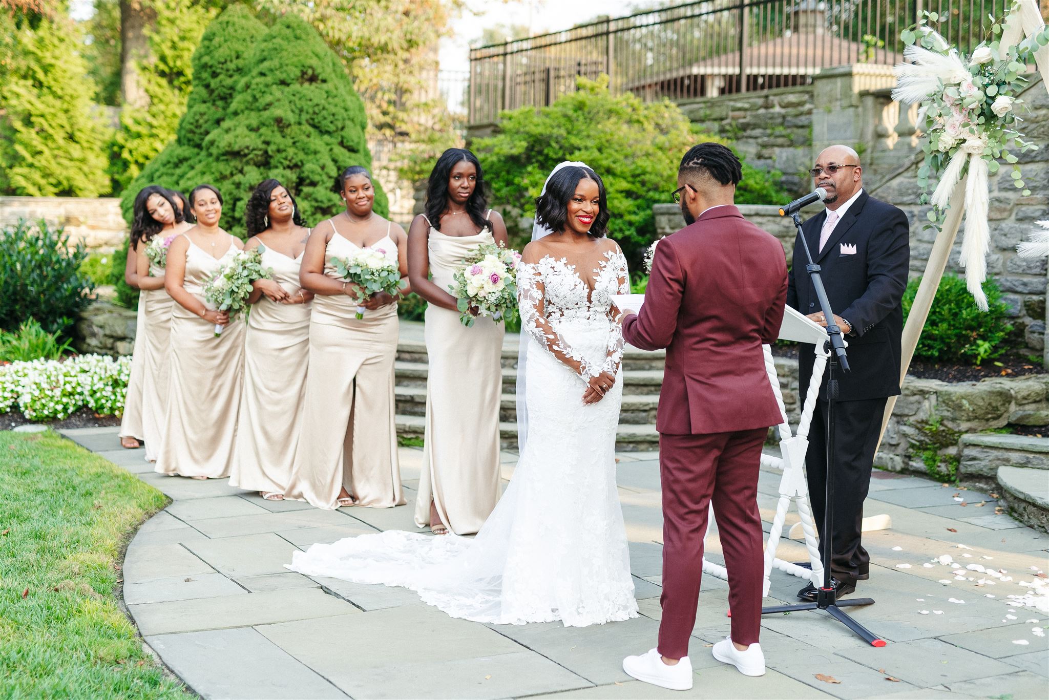 Groom reading his vows during the garden wedding ceremony with bride, officiant and bridesmaids in front of them, taken by Jason Moody Photography