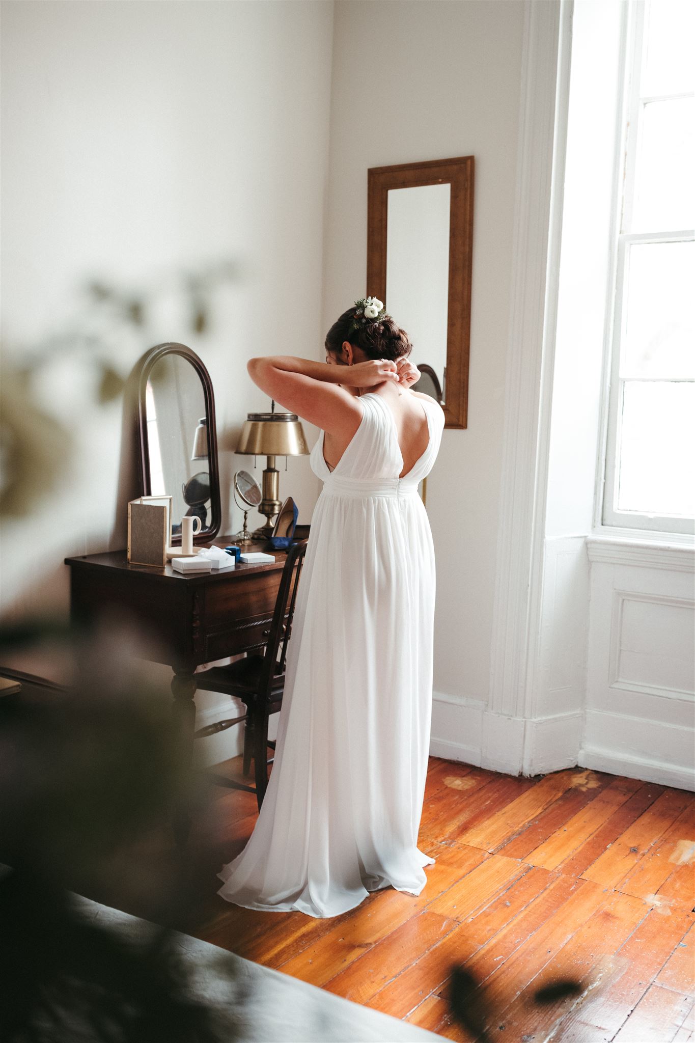 Shot for Jess Flynn - Why is Wedding Photography so Expensive + Why You Should Invest. Bride preparing for the wedding ceremony in front of a vanity.