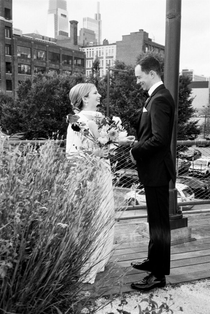 Shot for Kelly Giarrocco - Black and white photo of bride and groom smiling candidly at each other during their wedding shoot with Jason Moody Photography
