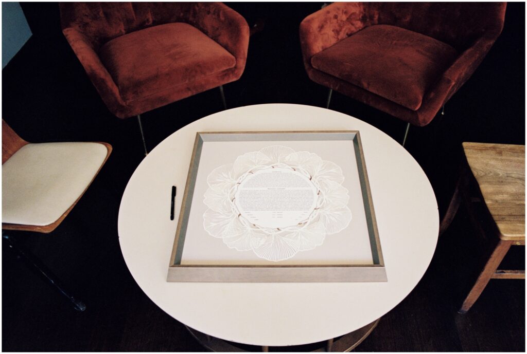 The ketubah sits on a coffee table.