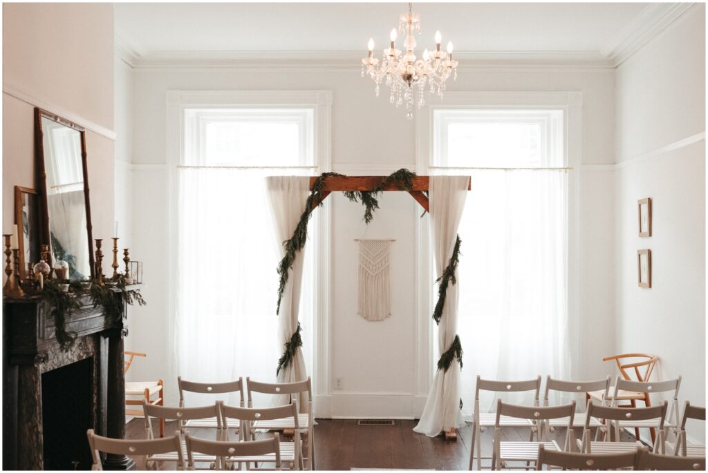 A wedding arch is draped with white fabric and ribbons at one of the small wedding venues in Philadelphia..