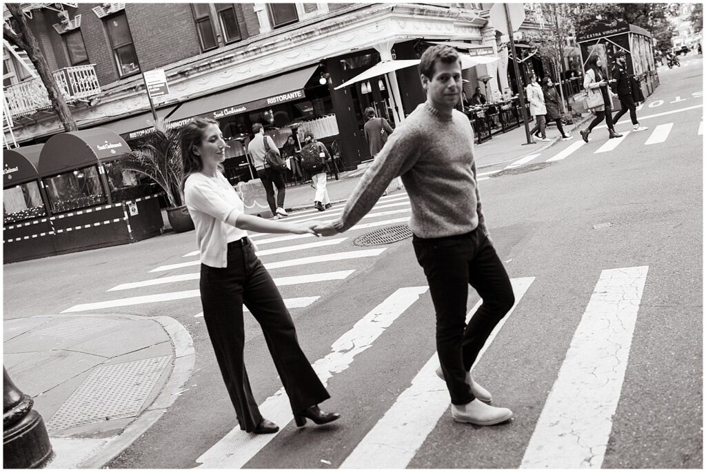 Matt holds Jess's hand as the cross a street in the West Village.