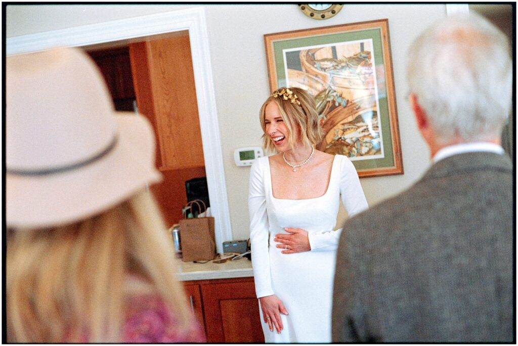 A bride talks with family members in her home.