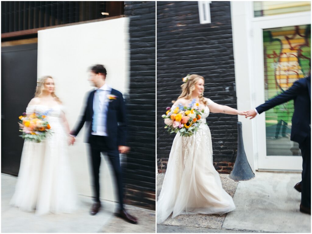 A couple in wedding attire walks down a Philadelphia sidewalk.