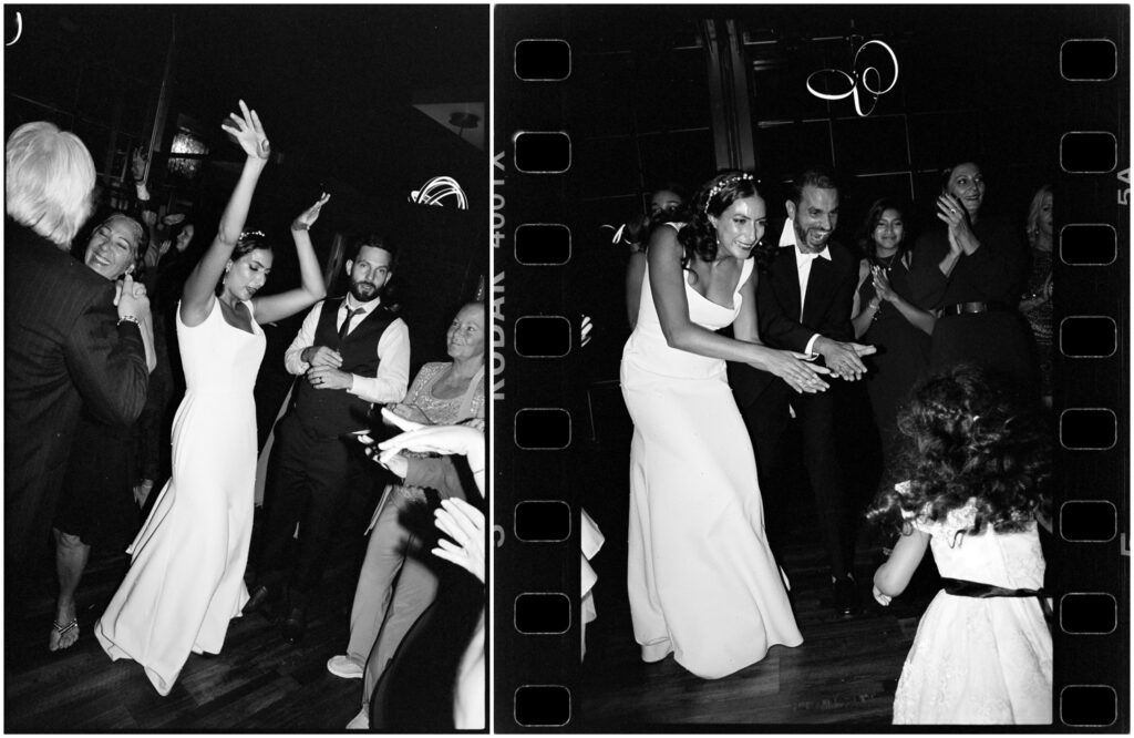 A bride and groom dance with a small child at their Philadelphia wedding reception.