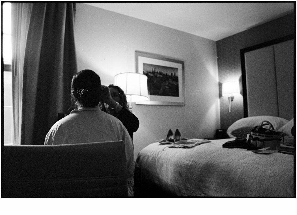 A makeup artist applies bridal makeup in a Philadelphia hotel room.