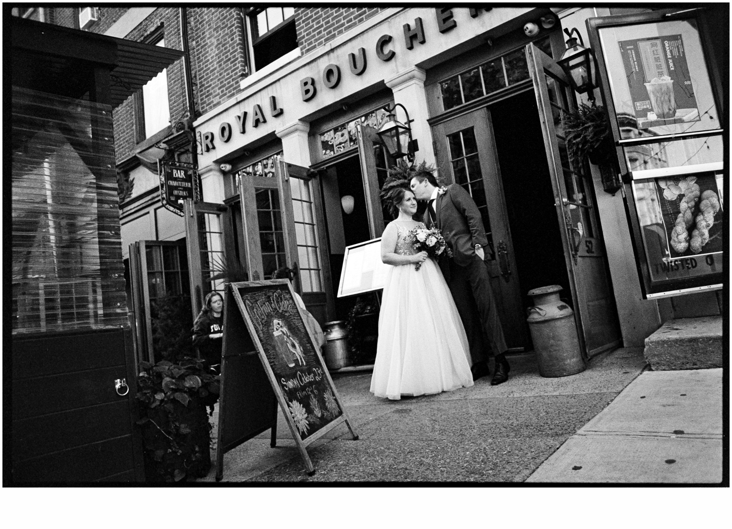 A bride and groom kiss outside Royal Boucherie.