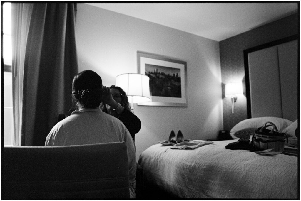 A makeup artist applies bridal make up in a Philadelphia hotel room.