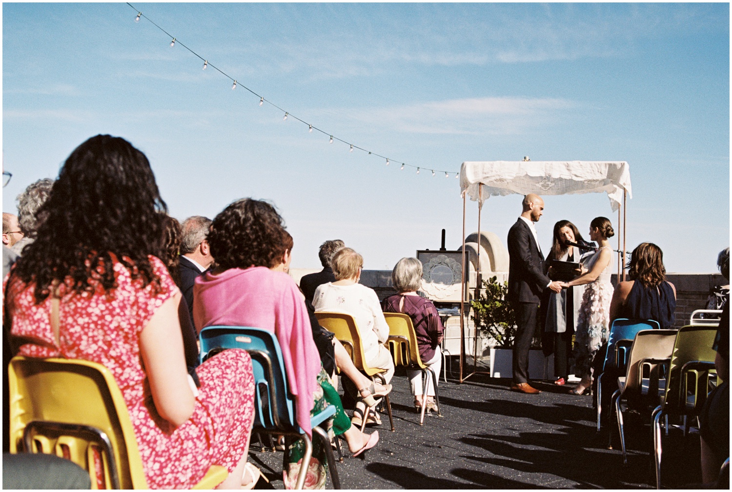 A bride and groom stand under a chuppah at a Philadelphia wedding venue.