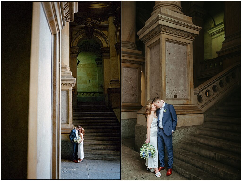 A bride and groom pose in a grand hallway after their Philadelphia City Hall wedding.