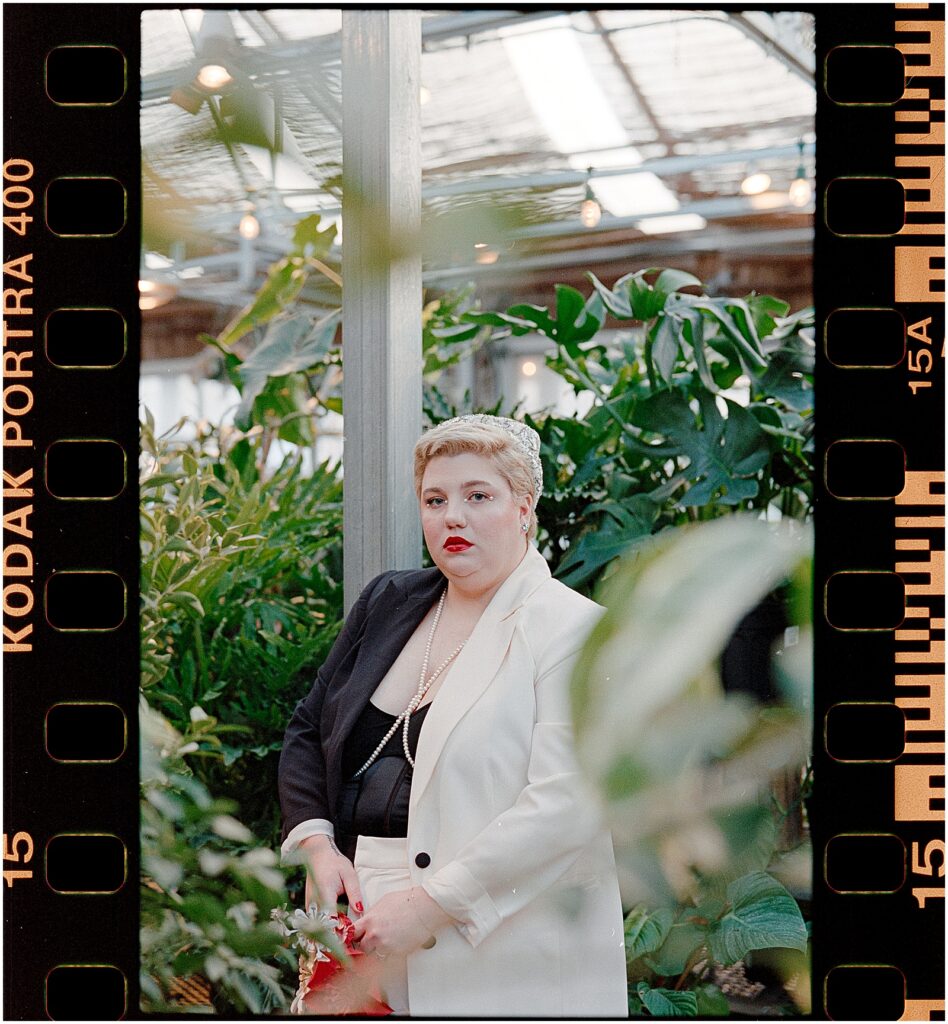 Devon poses for a wedding portrait in the greenhouse at Terrain.