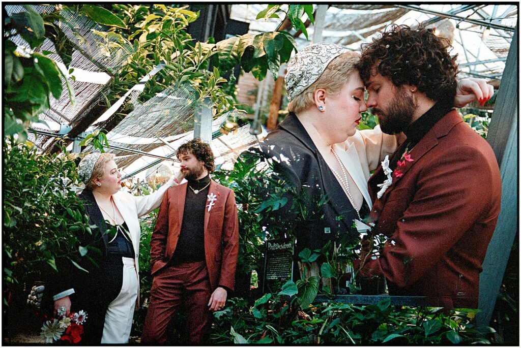 Steve and Devon press their foreheads together while they pose for wedding portraits in the greenhouse of Terrain.