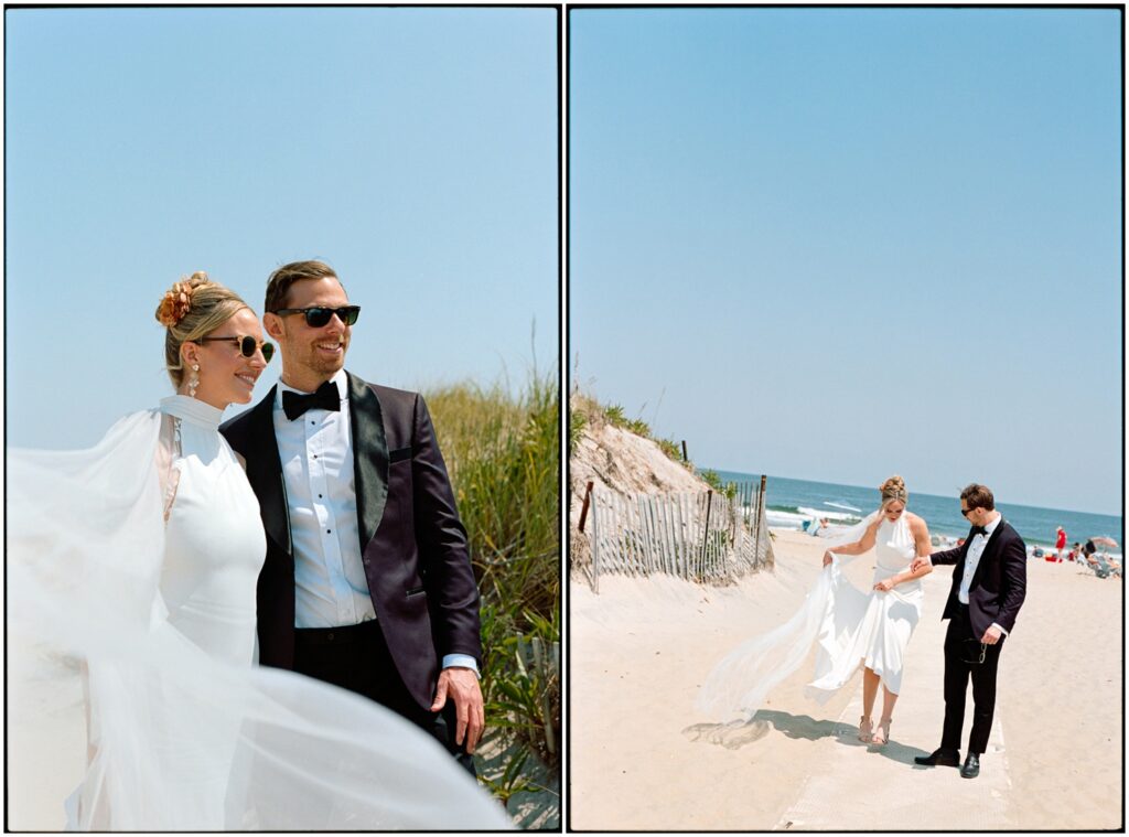 A bride and groom at a destination wedding walk across a sandy beach in wedding attire.