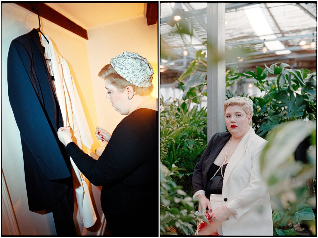 A marrier straightens their wedding suit jacket on its hanger.