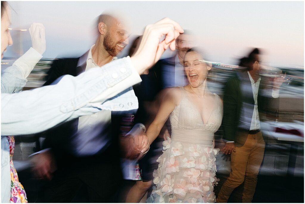 A bride and groom dance in a blurry wedding photo.