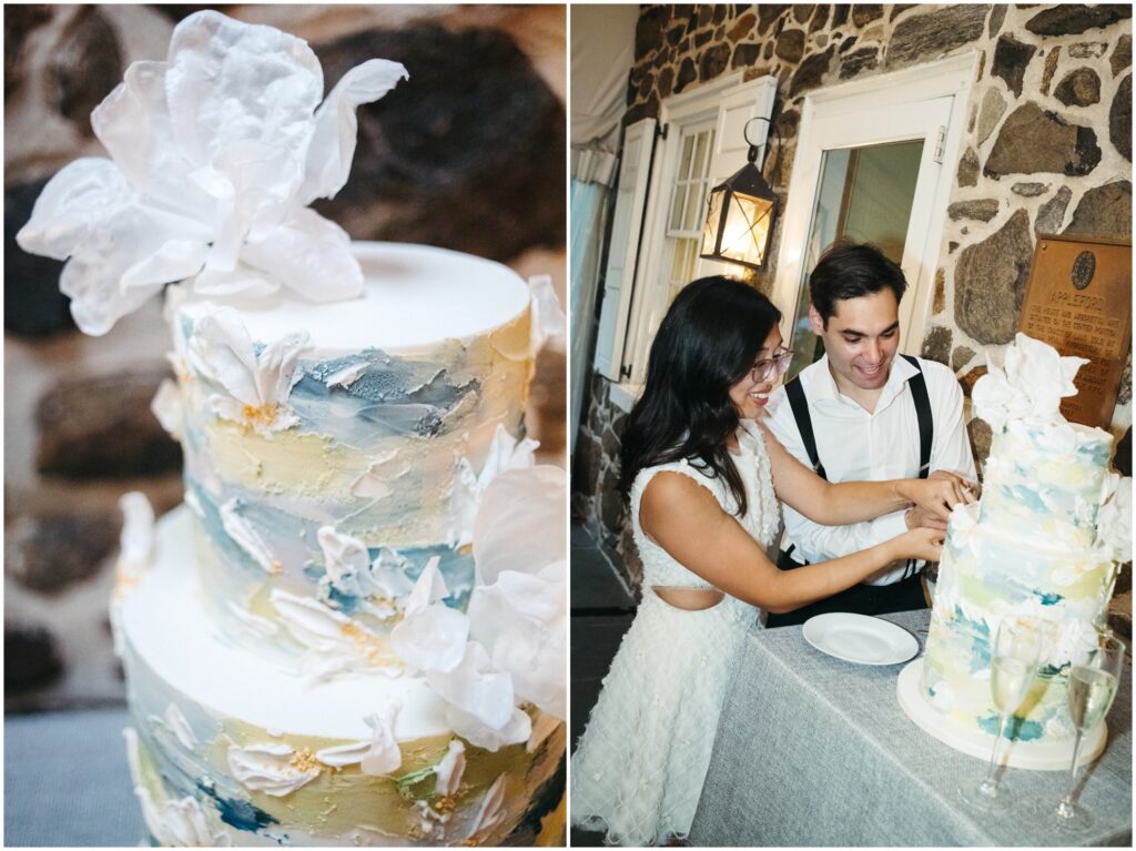 A bride and groom cut into a colorful wedding cake at a Philadelphia wedding venue.