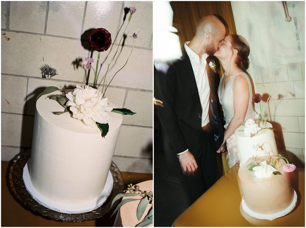A bride and groom kiss at their cake cutting.