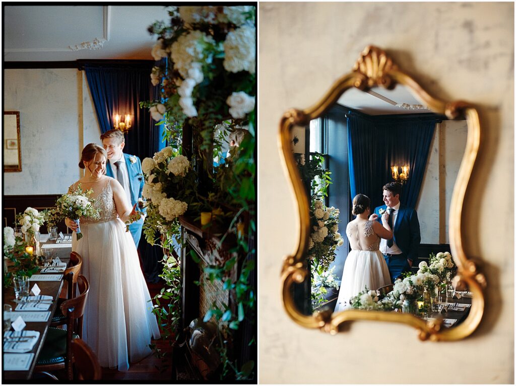 A bride and groom walk through a reception space decorated with flowers in a Philadelphia wedding venue.