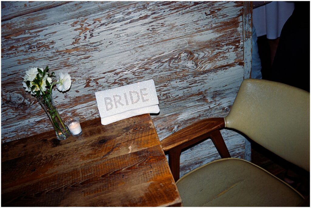 A sign on a restaurant table reads "Bride."