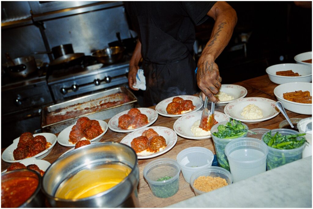 A chef puts meatballs on plates for a rehearsal dinner in Philadelphia.