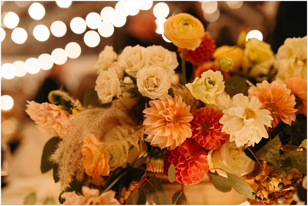 Lights shine behind a bouquet of wedding flowers.