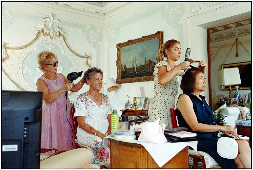 Two women style family members' hair before an Italian wedding.