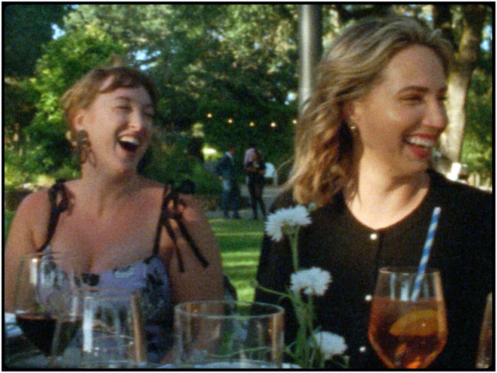 Guests laughing during dinner filmed by the Super 8 wedding videographer