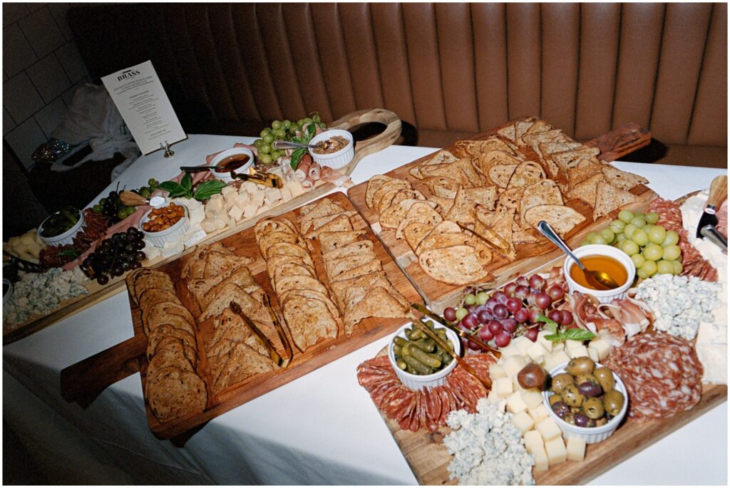A diverse spread of delectable appetizers and entrees adorn the tables, showcasing the culinary delights of American Brass, Long Island City, NY, at an engagement party.