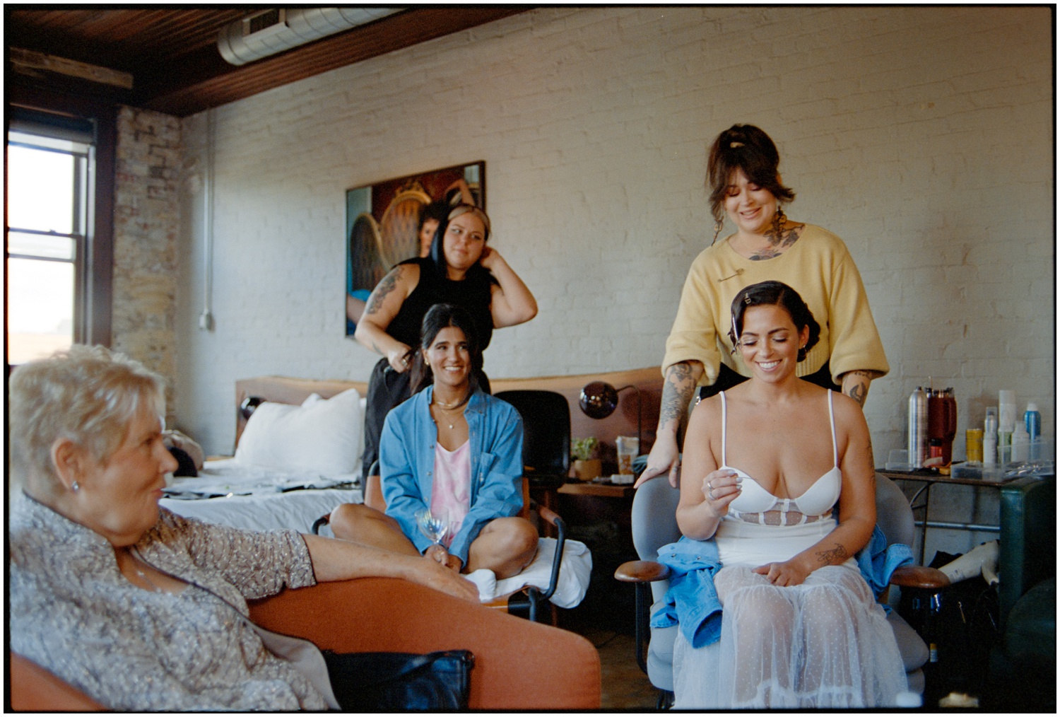 A Philadelphia bride getting ready for her wedding day, surrounded by makeup and hair styling tools.