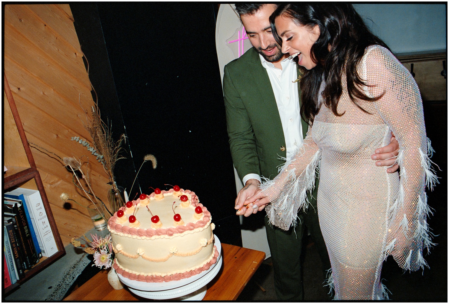 The couple ecstatically cuts their heart shaped cake at their Philadelphia wedding